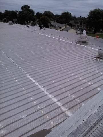 Exposed fastener metal roofing repair in Naperville IL Before