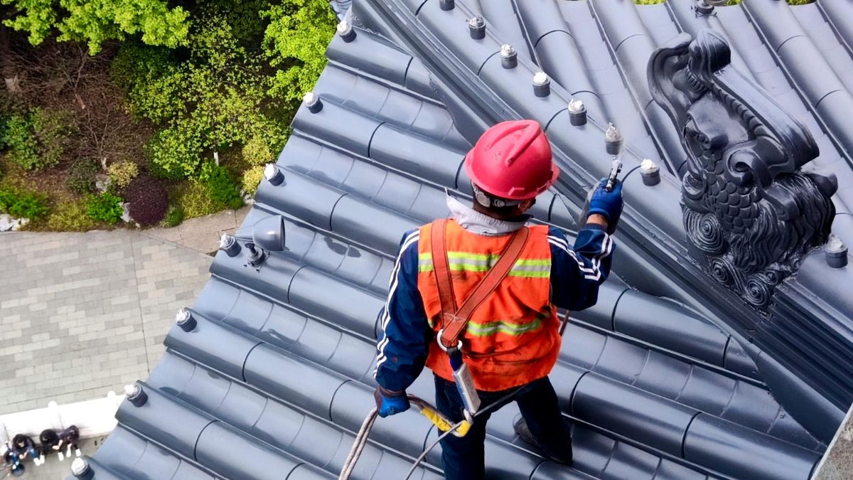 A Professional Roofer Working on a Roof - Roof Maintenance