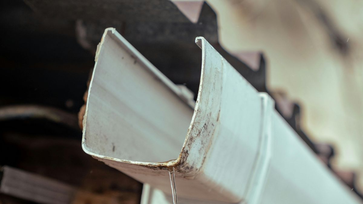 Close-Up View of a Pipe Suspended From a Roof - Winter Gutter Maintenance