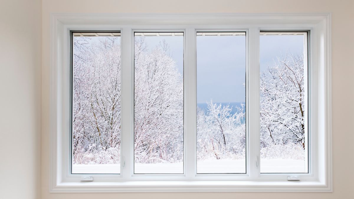 A window framed by snow, illustrating winter care to keep warmth inside and cold outside.