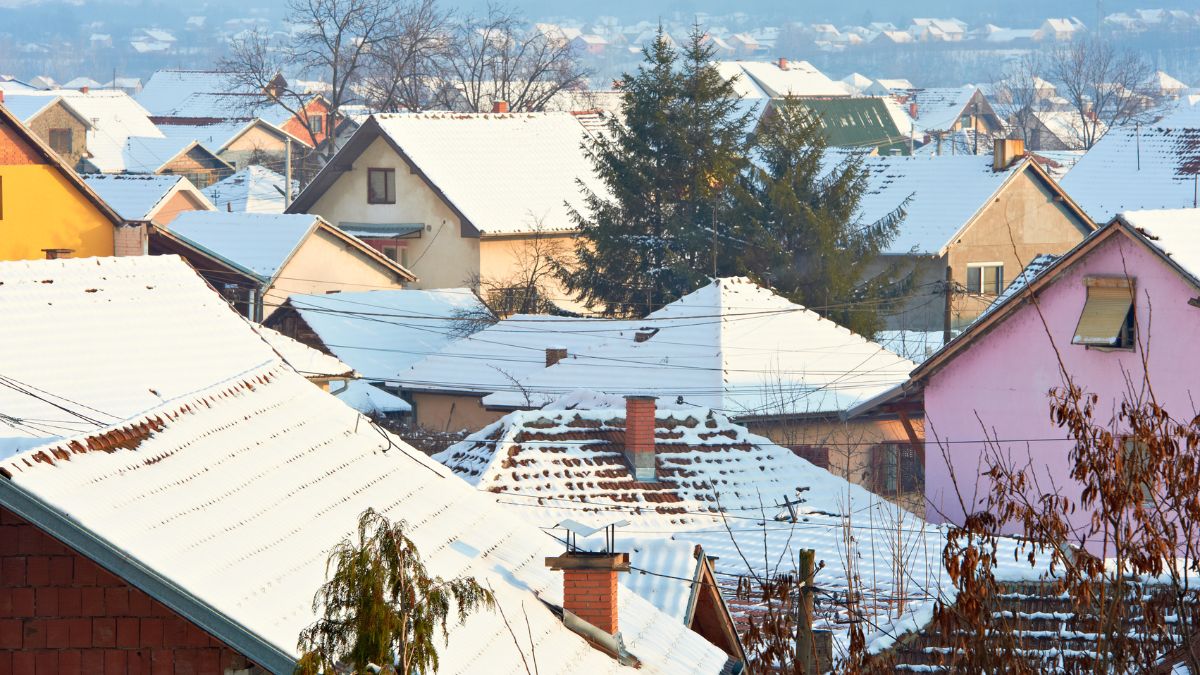 Vibrant homes covered in snow, emphasizing the need for proper roof preparation for heavy January storms in Illinois