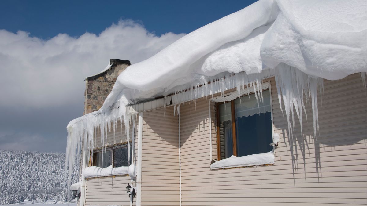 A roof covered in ice, illustrating the risks of winter weather and the importance of addressing snow and ice damage promptly.